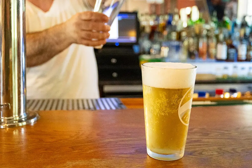 A glass of beer on the bar at Catskill Mountain Pizza.